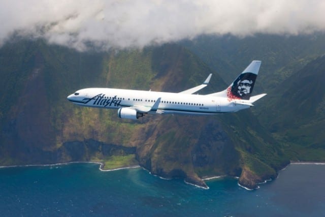 An Alaska Airlines Jet flying above the Molokai Cliffs