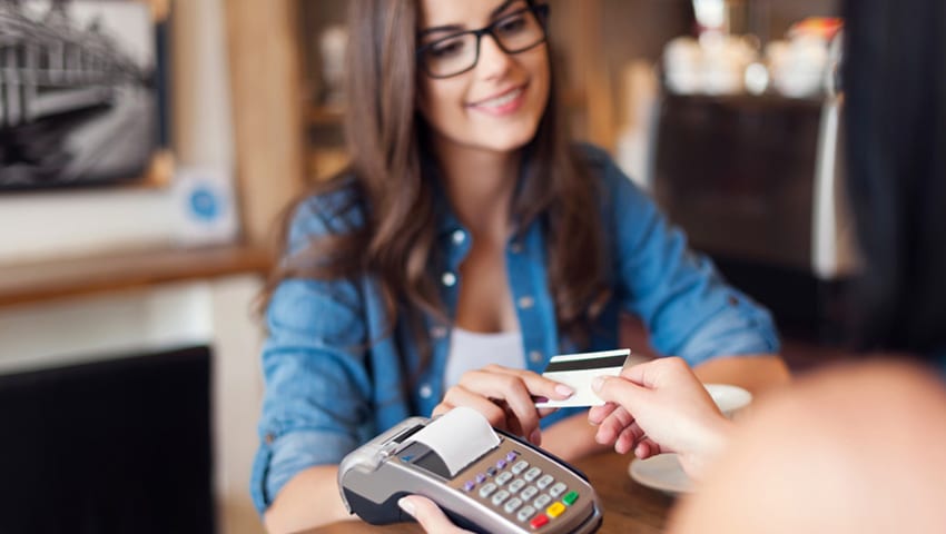 women paying with a credit card