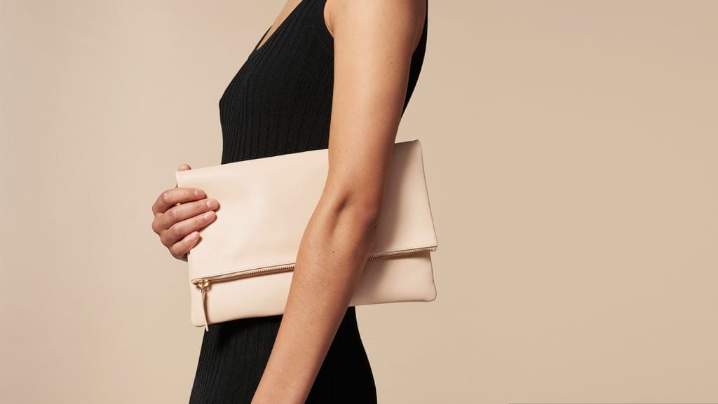Women holding Everlane leather clutch