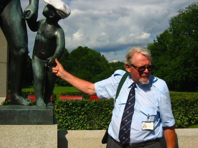 Tour guide pointing at a statue