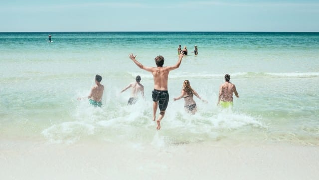 People jumping into the ocean