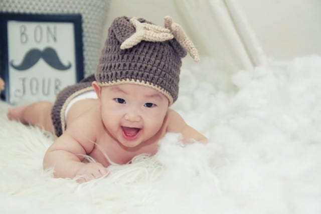 baby playing on a rug