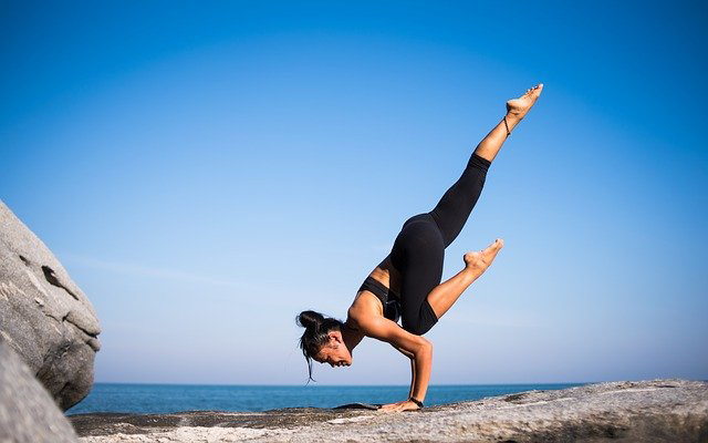 woman yoga on cliff