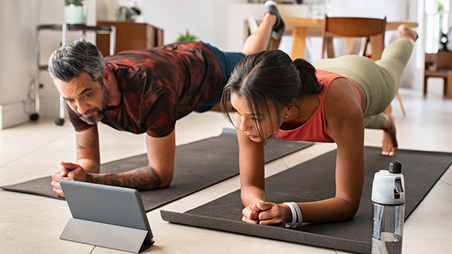 fitness couple using deals on digital fitness content at home